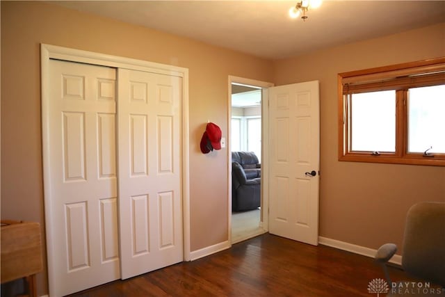 6376 Lander Ln, Dayton, OH 45459 - bedroom with a closet, dark wood-type flooring, multiple windows, and baseboards