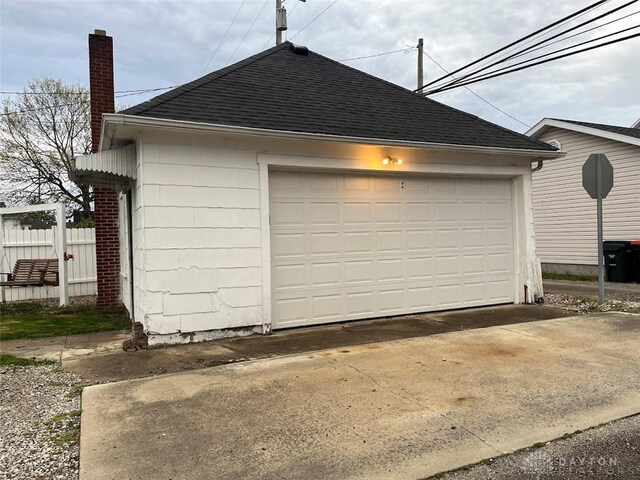 detached garage featuring fence