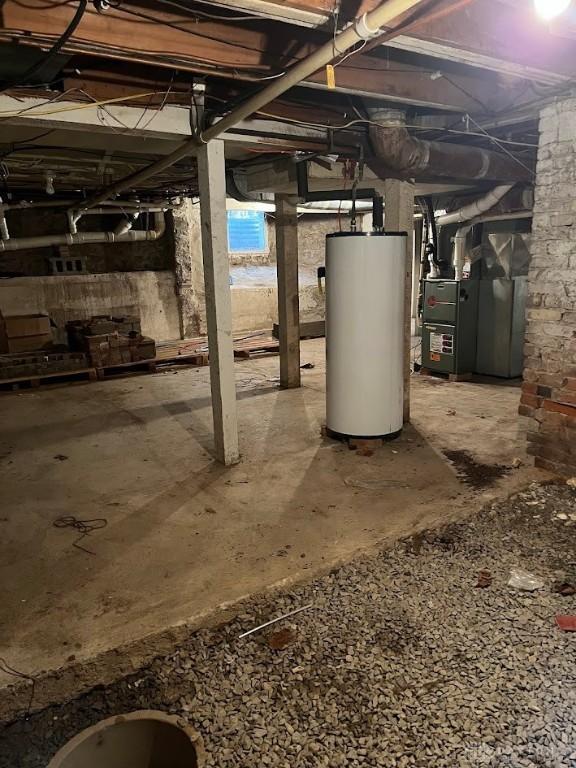 unfinished basement featuring gas water heater and heating unit