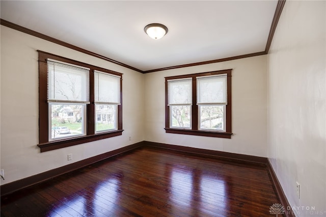 unfurnished room with crown molding, baseboards, and dark wood finished floors