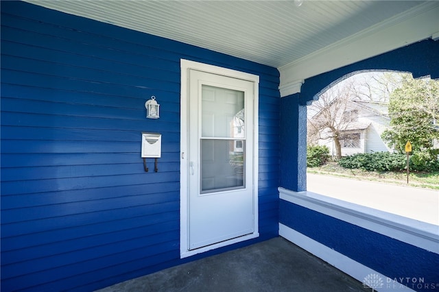 view of exterior entry with covered porch