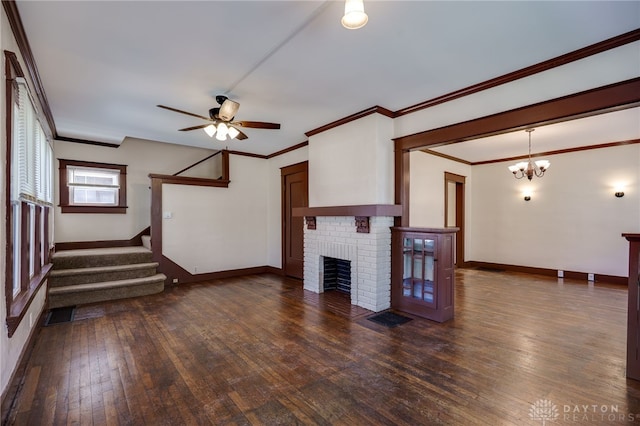 unfurnished living room featuring a fireplace, dark wood-style flooring, ceiling fan with notable chandelier, and baseboards