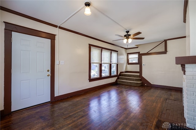 unfurnished living room with crown molding, a ceiling fan, stairway, baseboards, and hardwood / wood-style flooring