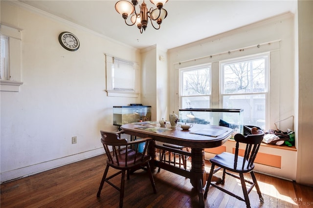 dining room with wood-type flooring, baseboards, an inviting chandelier, and ornamental molding