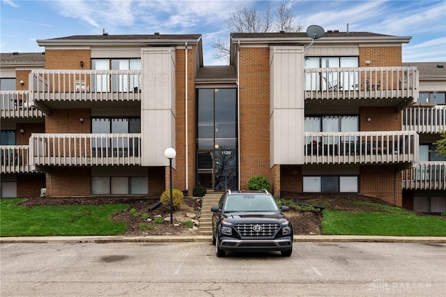view of building exterior featuring uncovered parking