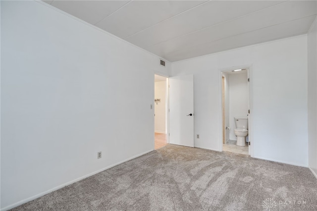 carpeted empty room featuring visible vents and baseboards