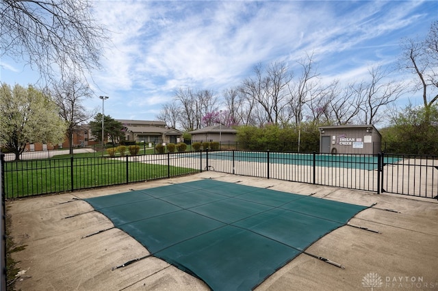 community pool with a yard and fence