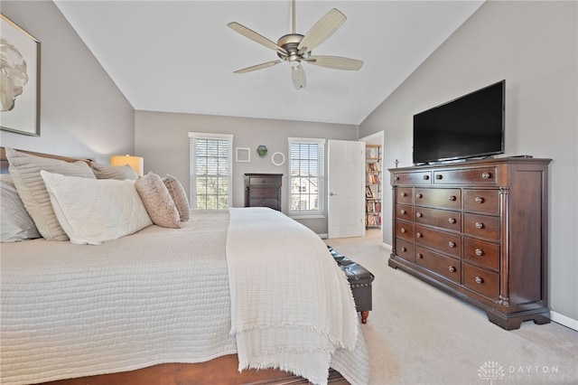 bedroom featuring light colored carpet, baseboards, a ceiling fan, and lofted ceiling