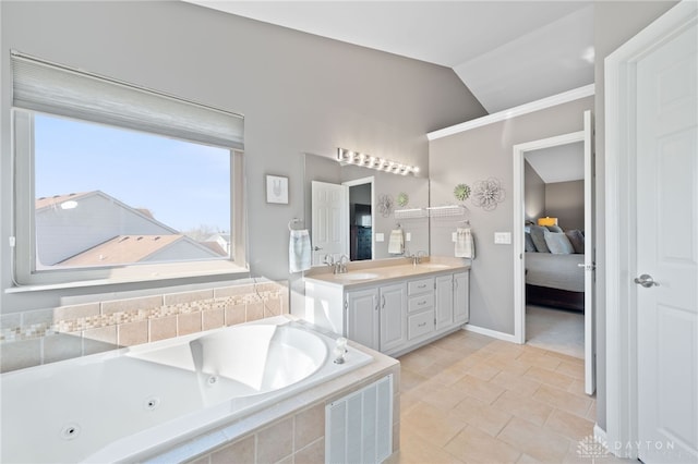 bathroom with a sink, a whirlpool tub, double vanity, and vaulted ceiling