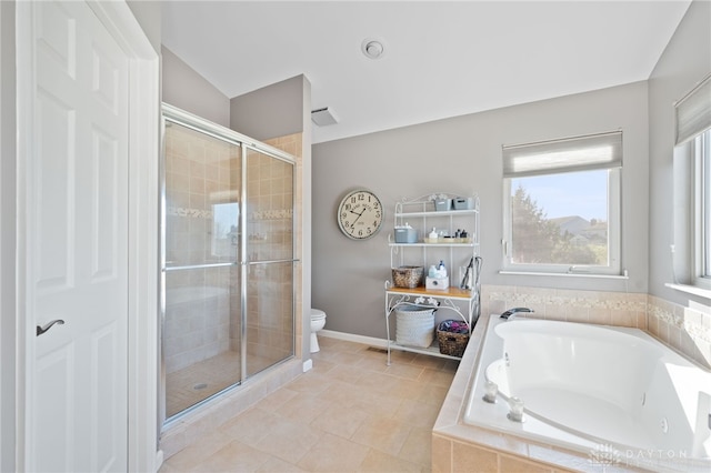 bathroom with a shower stall, a bath, baseboards, and toilet