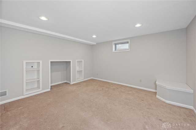 basement featuring baseboards, carpet, and recessed lighting