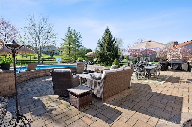 view of patio / terrace with an outdoor pool, grilling area, and outdoor dining area