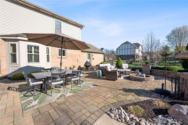 view of patio featuring grilling area, a fire pit, and outdoor dining area