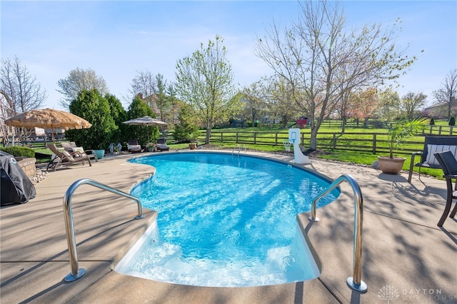view of swimming pool with a patio area, fence, a fenced in pool, and a yard