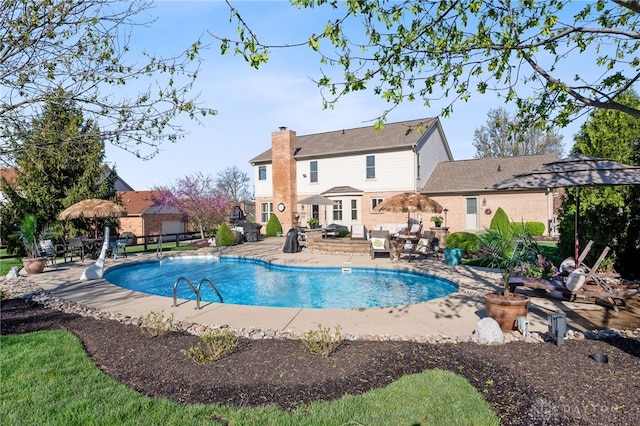 outdoor pool with a patio area