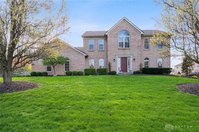 view of front of property featuring brick siding and a front lawn