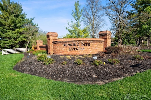 community sign with a yard and fence