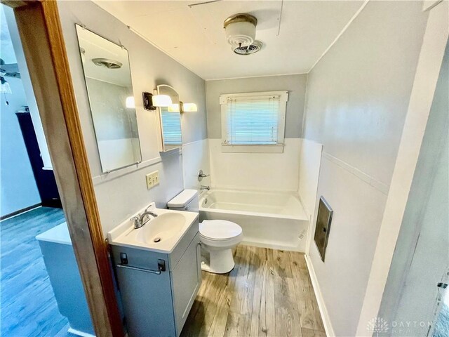 127 S Main St, Lewisburg, OH 45338 - full bath with wood finished floors, a bath, and vanity