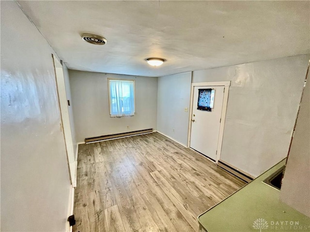 127 S Main St, Lewisburg, OH 45338 - foyer featuring a baseboard heating unit and light wood-type flooring
