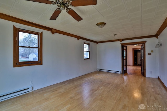 spare room with ornamental molding, a ceiling fan, and a baseboard heating unit
