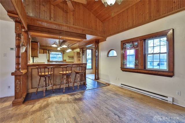 bar with wood ceiling, wood finished floors, a baseboard radiator, and ceiling fan with notable chandelier