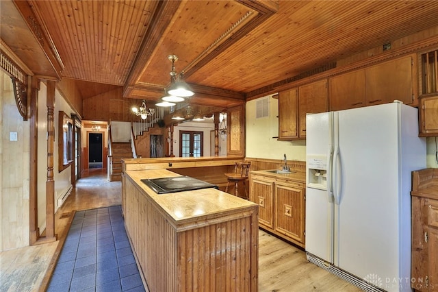 kitchen with wooden ceiling, white fridge with ice dispenser, a sink, butcher block counters, and a baseboard heating unit