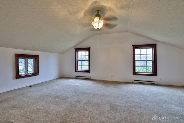 bonus room featuring baseboard heating, a textured ceiling, carpet flooring, and a ceiling fan