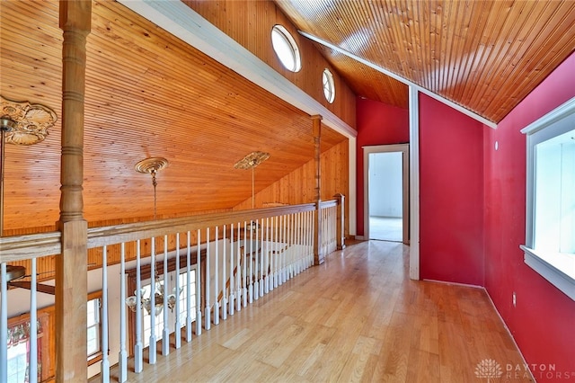 corridor featuring wooden ceiling, wood finished floors, and lofted ceiling