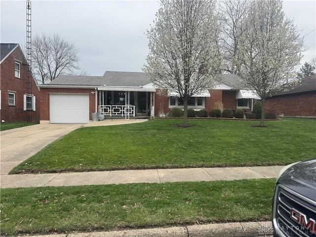 single story home featuring an attached garage, concrete driveway, a front lawn, and brick siding