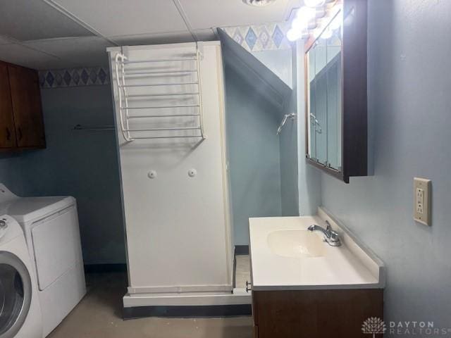 bathroom featuring washer and clothes dryer, finished concrete floors, and vanity