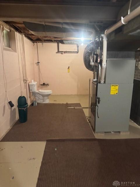 unfinished below grade area featuring heating unit