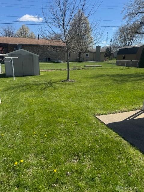 view of yard with an outbuilding and a shed