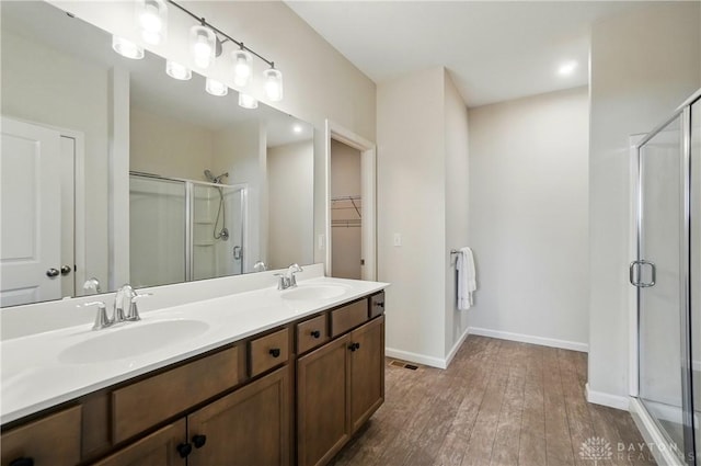 1110 Billingsley Dr, Batavia, OH 45103 - full bath featuring a stall shower, hardwood / wood-style floors, a sink, and a walk in closet