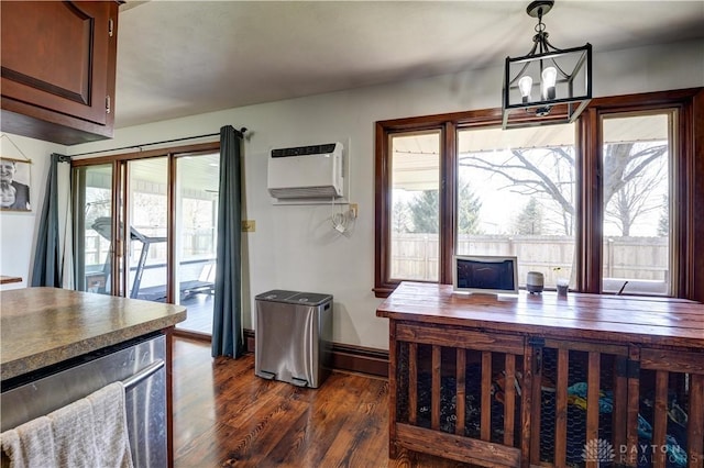 dining space featuring a wall unit AC, an inviting chandelier, and dark wood finished floors