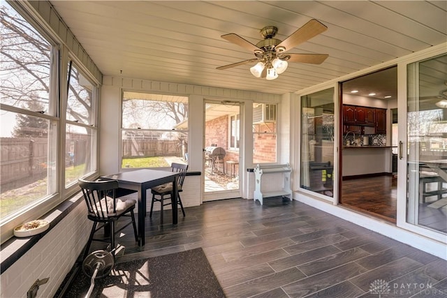 sunroom with a ceiling fan and plenty of natural light