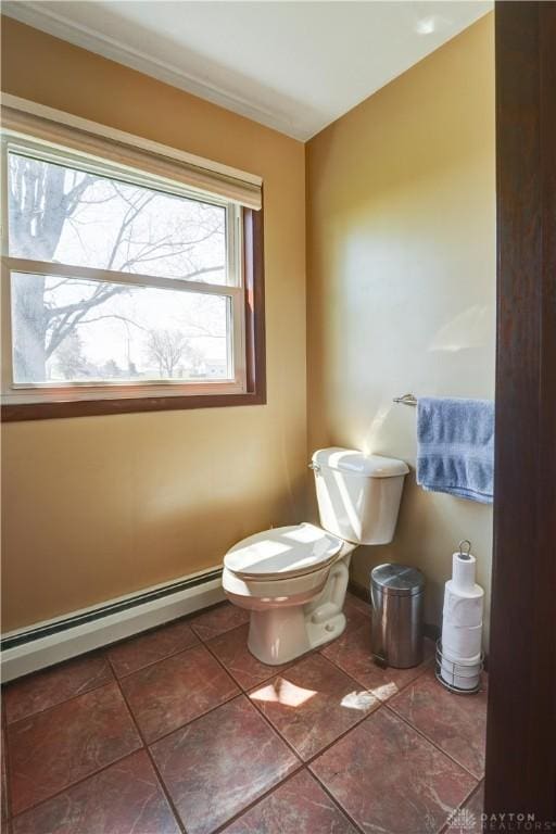 bathroom with toilet, a baseboard radiator, and tile patterned flooring