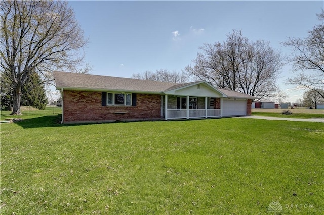 ranch-style house with aphalt driveway, a front yard, a porch, and an attached garage