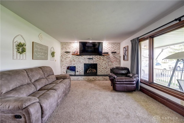 carpeted living area with a brick fireplace