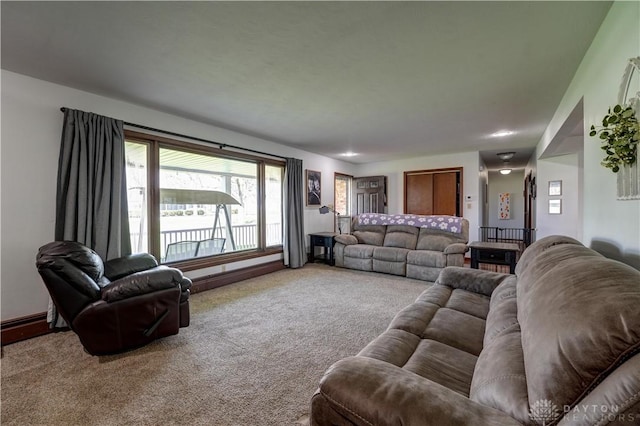 carpeted living room featuring baseboards