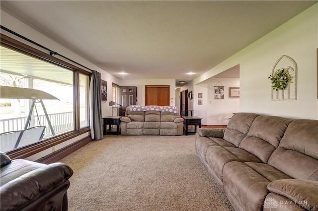 carpeted living area with a baseboard radiator
