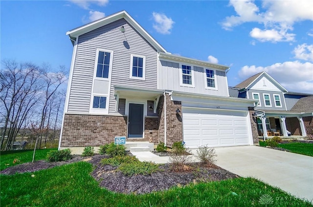 1629 Arden Bnd, Fairborn, OH 45324 - view of front of property with brick siding, driveway, board and batten siding, and a garage