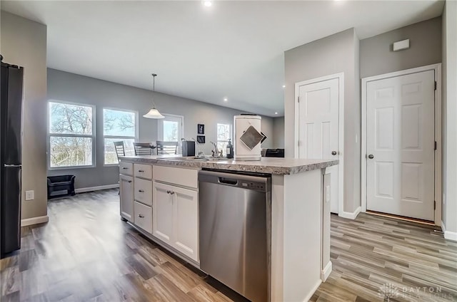 1629 Arden Bnd, Fairborn, OH 45324 - kitchen with light wood finished floors, dishwasher, a sink, and white cabinets