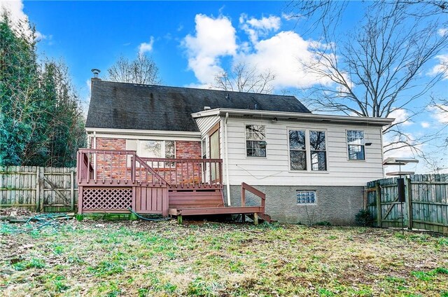 back of house featuring a fenced backyard and a wooden deck