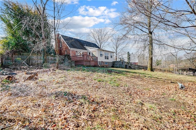 view of yard with a wooden deck and fence