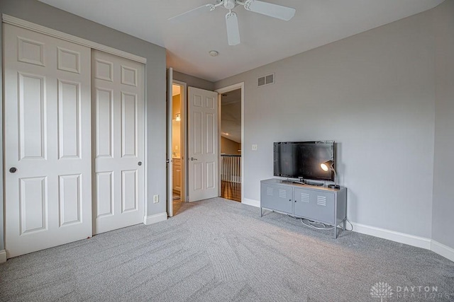 unfurnished bedroom featuring visible vents, baseboards, a closet, ceiling fan, and carpet flooring