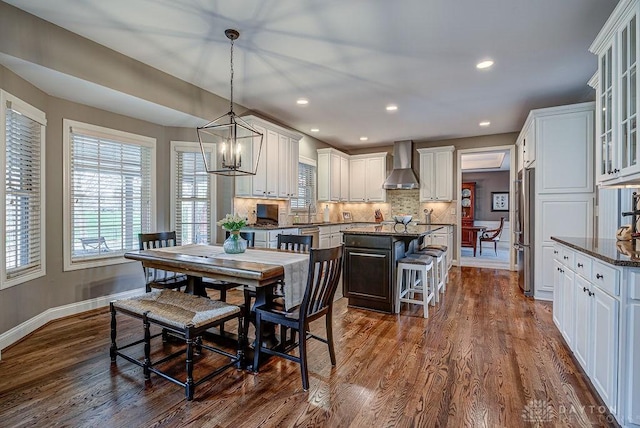 dining room featuring dark wood-type flooring, baseboards, recessed lighting, and a chandelier