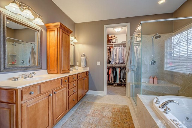 full bathroom with a tub with jets, a sink, a stall shower, double vanity, and tile patterned floors