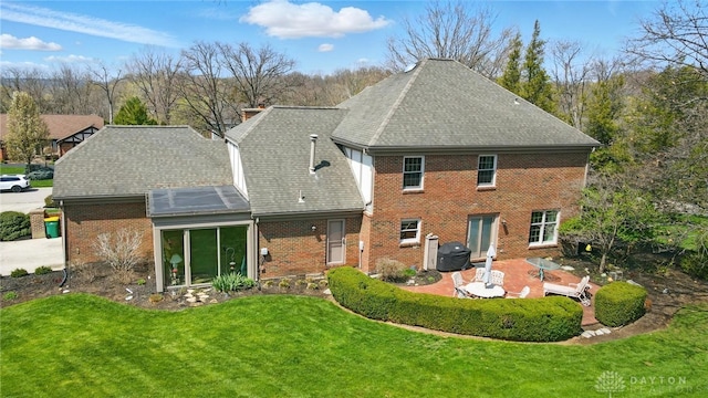 1458 Westwicke Pl, Washington Twp, OH 45459 - back of house featuring a patio area, brick siding, a yard, and roof with shingles
