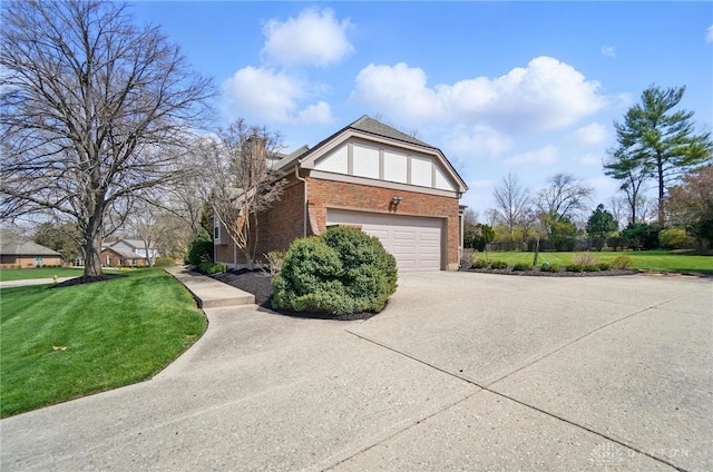 1458 Westwicke Pl, Washington Twp, OH 45459 - view of home's exterior featuring a chimney, driveway, brick siding, a garage, and a lawn