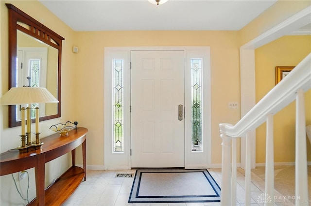 1458 Westwicke Pl, Washington Twp, OH 45459 - foyer featuring baseboards, tile patterned flooring, visible vents, and stairs